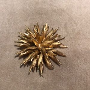 Gold colored brooch